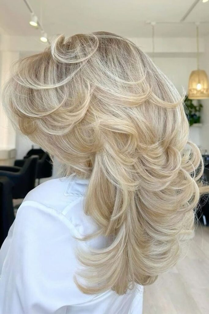 Long layered haircut with curtain fringe and soft movement around the face