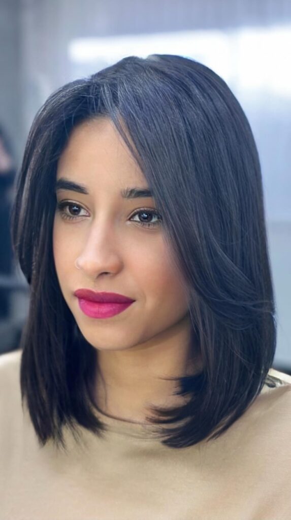 Face-framing lob with subtle layers around the cheekbones and jaw