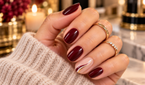 Elegant burgundy nail ideas for women over 50 with glossy and gold accents